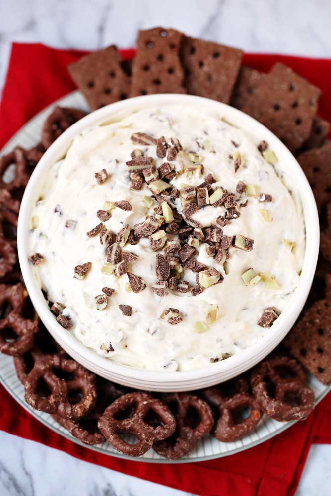 Overhead picture of a mint cheesecake dip sprinkles with pieces of andes mints.