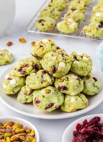 The finished Pistachio Pudding Cookies piled on a white plate.