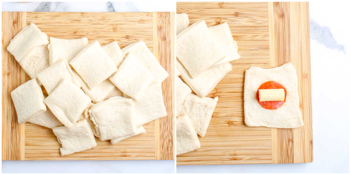 A wooden cutting board showing a tube of pizza dough cut into square pieces. One piece of dough is laid flat with a slice of pepperoni and a small chunk of mozzarella cheese placed in the center.