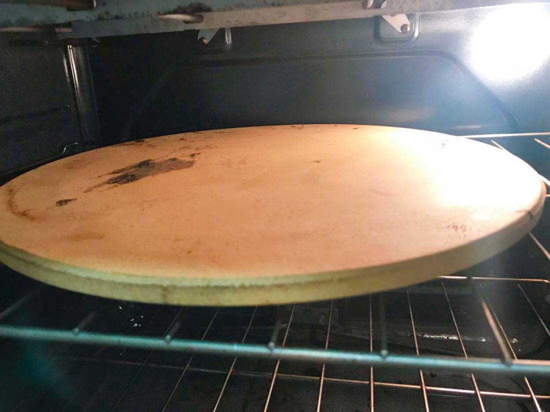 A pizza stone preheating in the oven. 