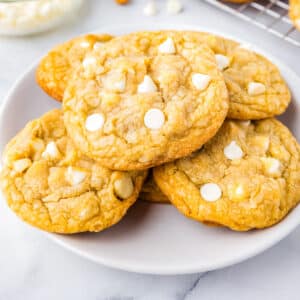 Five cookies on a white plate.