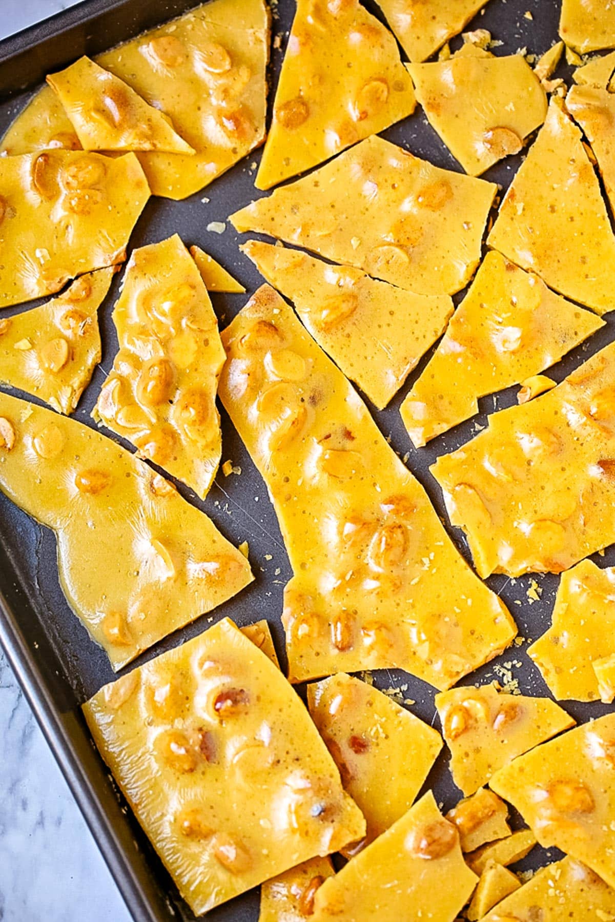Brittle pieces on a baking sheet.