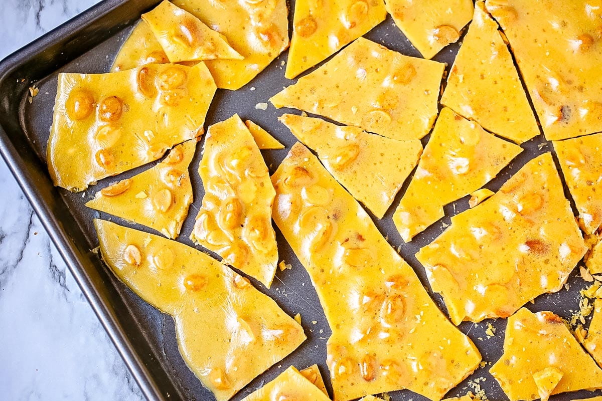 Peanut brittle on a rimmed baking sheet.
