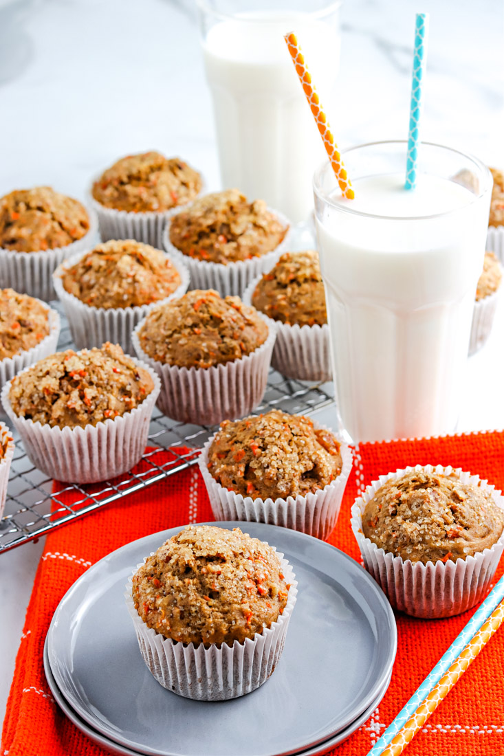A healthy carrot cakes on a serving plate and a wire rack.  Healthy Carrot Cake Truffles Recipe Healthy Carrot Muffins