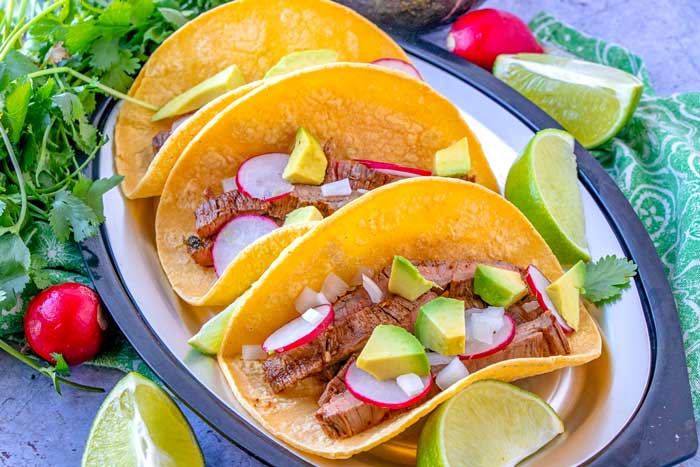 Tacos de carne asada on a plate.