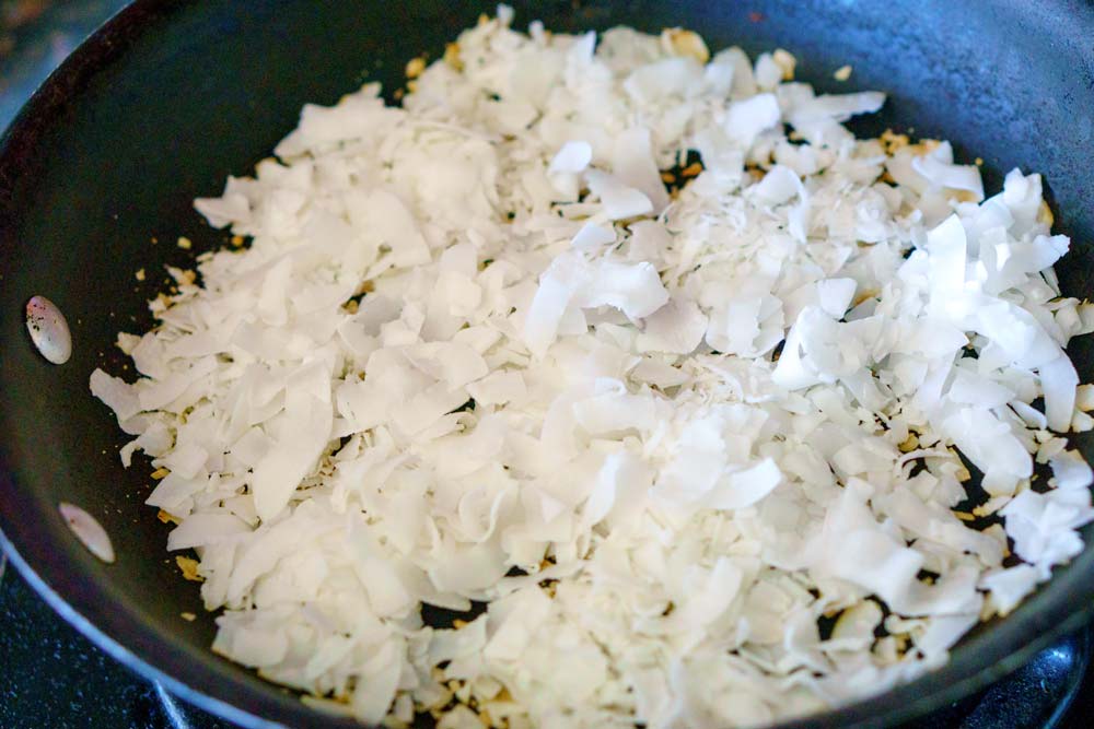 Shredded coconut in a skillet before it's toasted. 