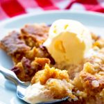 Apple Pie Dump Cake with a scoop of ice cream on a plate