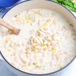 White chicken chili in a white woup pot.