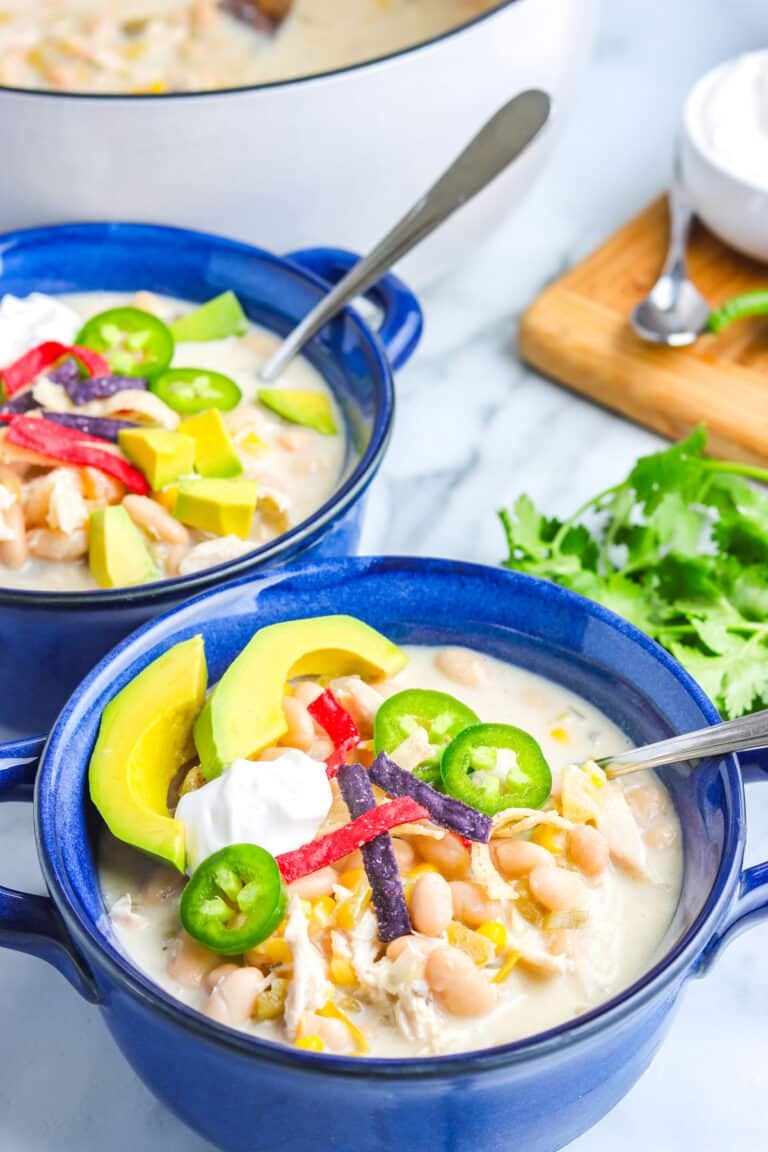 A bowl of white chicken chili stovetop recipe in white serving bowls.