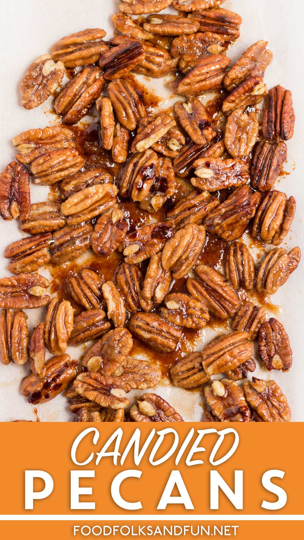 Candied pecans on a serving platter with text overlay for Pinterest