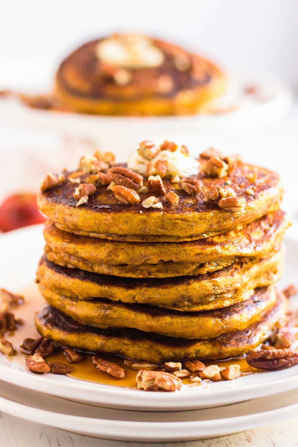 A plate of stacked pumpkin pancakes