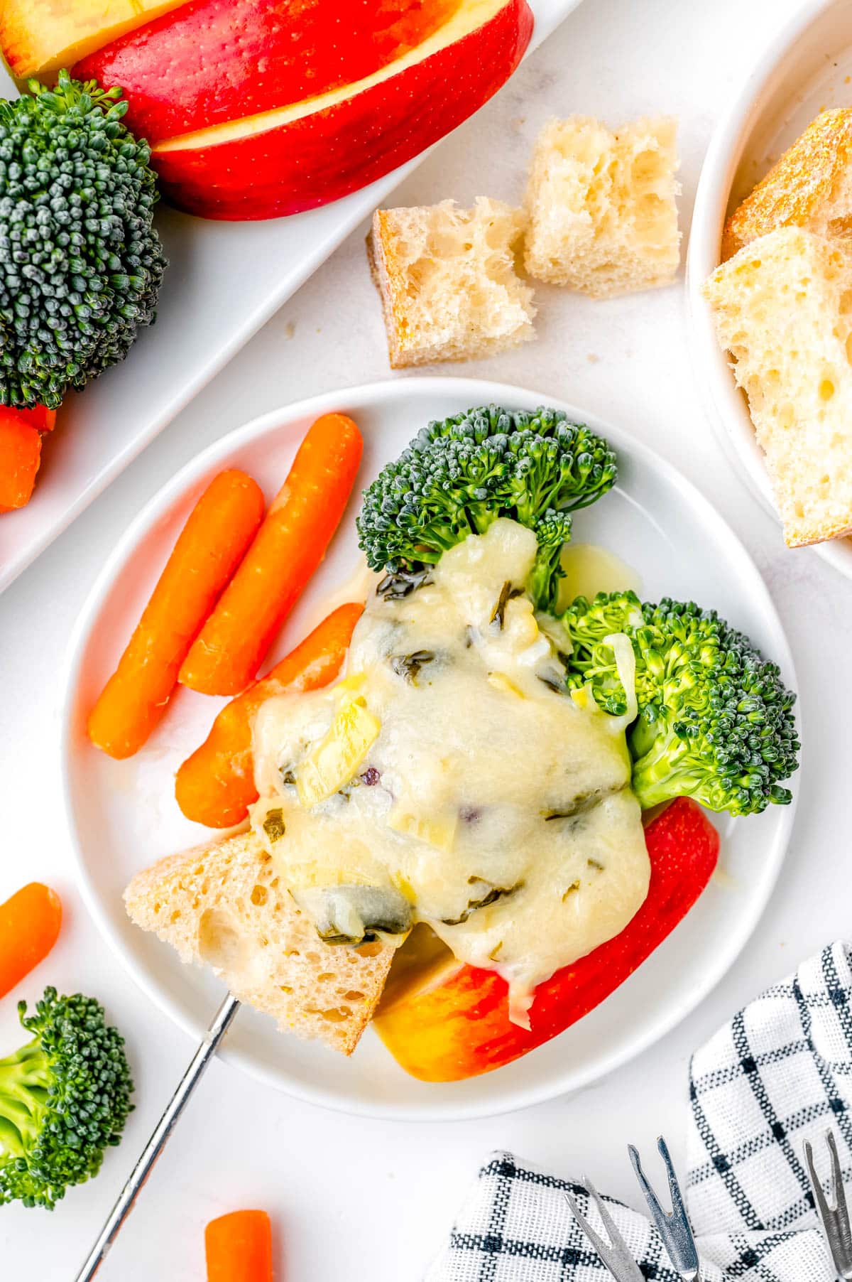 Cheese fondue spread over some vegetables.