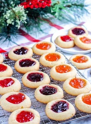 The finished Jam Thumbprint Cookies on a wire rack.
