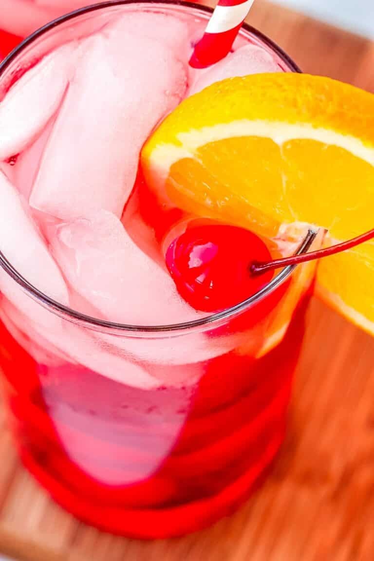 A Shirley Temple Drink garnished with an orange slice and maraschino cherry.