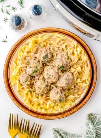 An overhead picture of the finished Swedish Meatballs over a bed of butter noodles.