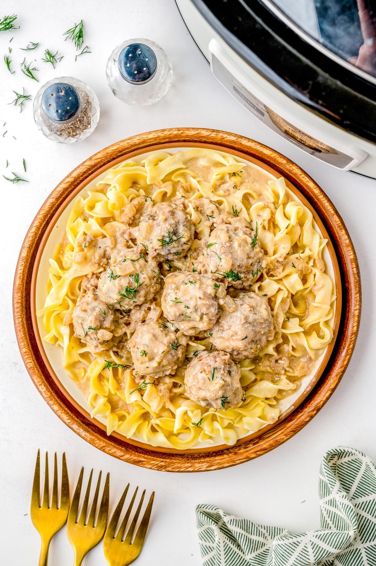 An overhead picture of the finished Swedish Meatballs over a bed of butter noodles. 
