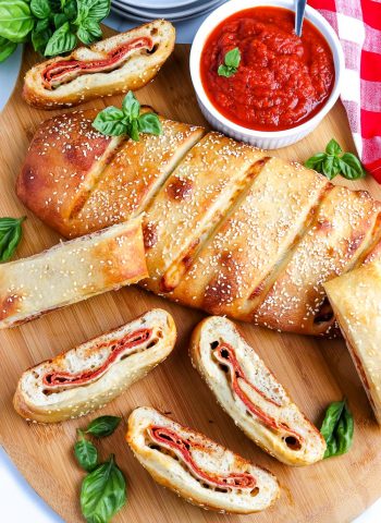 An overhead picture of the finished Pepperoni Stromboli sliced on a wooden cutting board.