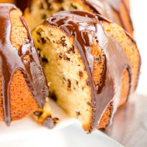 A close up picture of a piece of Chocolate Chip Bundt Cake being sliced.