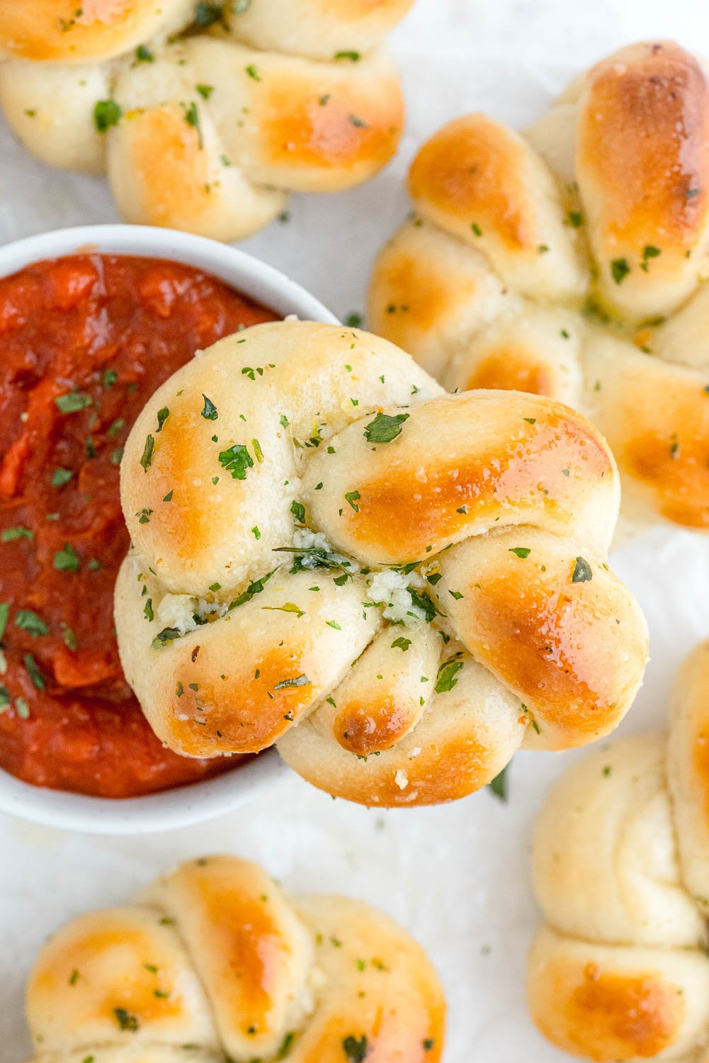 Garlic knots with pizza sauce for dipping.