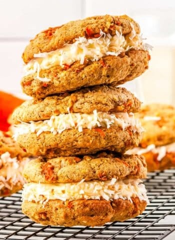 Three of the finished Carrot Cake Whoopie Pies recipes are stacked on top of each other.