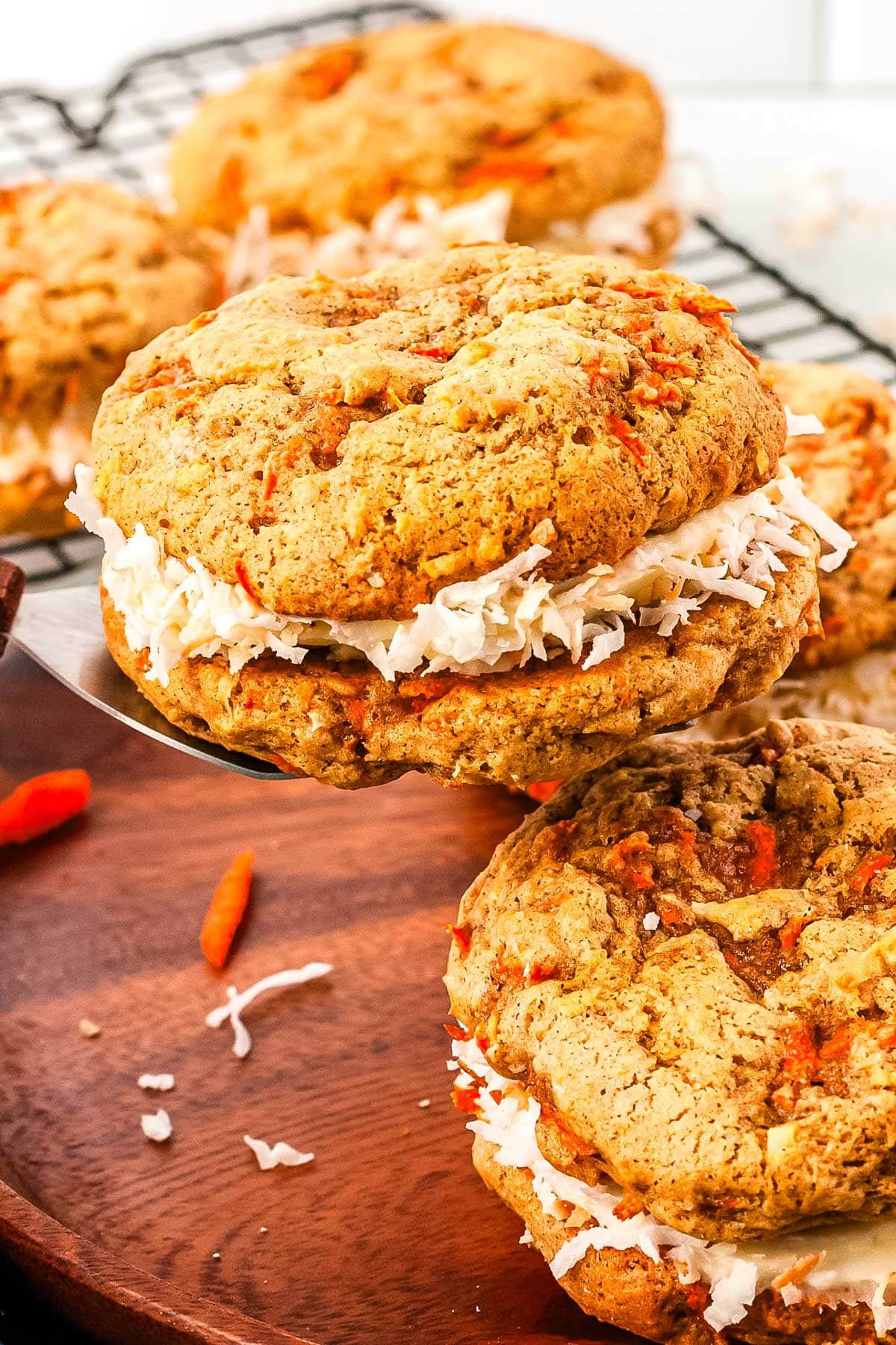 Carrot Cake Whoopie Pies on a wooden platter. 
