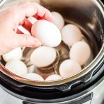 Placing eggs in the Instant Pot to hard boil them