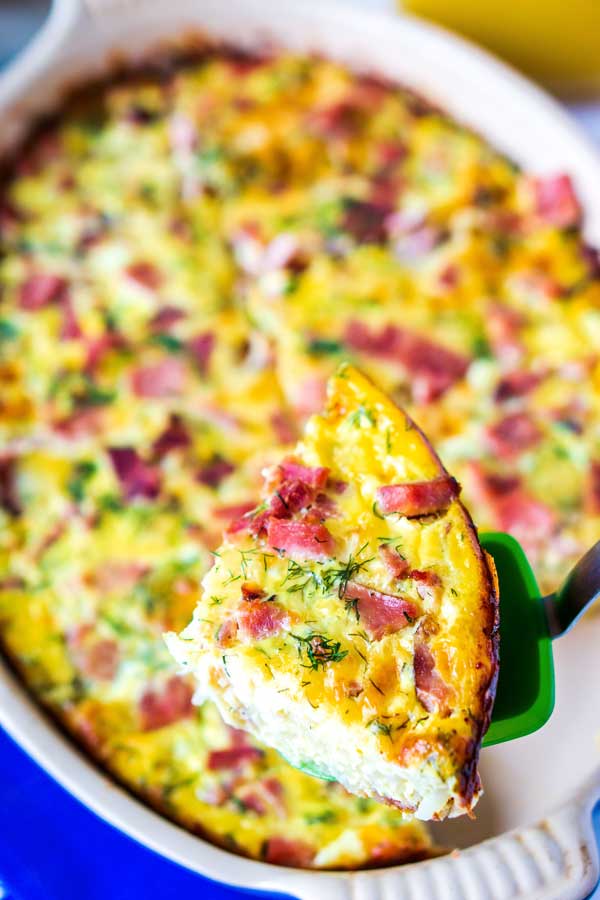 A slice of ham and cheese brunch bake on a spatula.