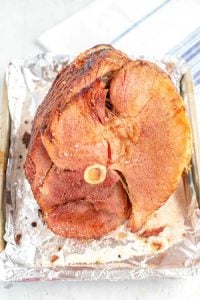 Place the cooked ham on a foil lined baking sheet.