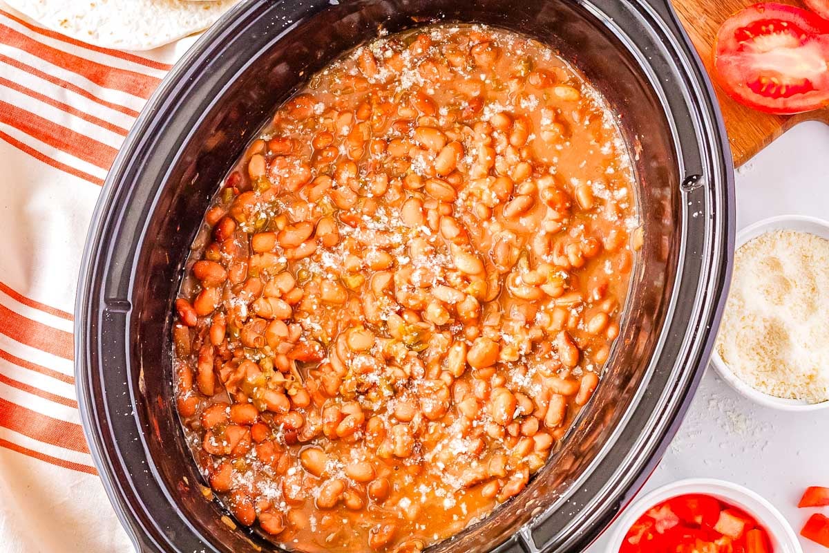 The finished pinto beans in a slow cooker made with green chile.