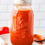 The Chipotle Enchilada Sauce in a storage jar.