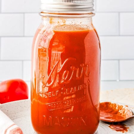 The Chipotle Enchilada Sauce in a storage jar.