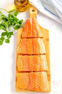 Using a paring knife, cut the salmon fillets into 4 equal pieces.