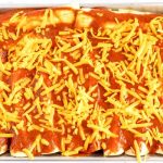 Sprinkle with cheddar cheese and cook the enchiladas for 22 minutes.
