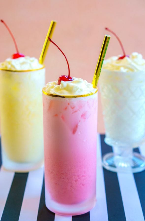 Cherry, pineapple, and coconut Italian Cream Sodas in frosted glasses.