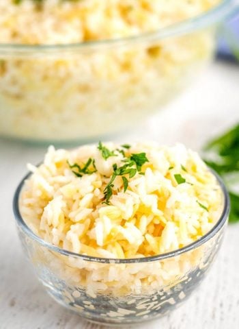 A close up picture of rice pilaf with chopped parsley on top.
