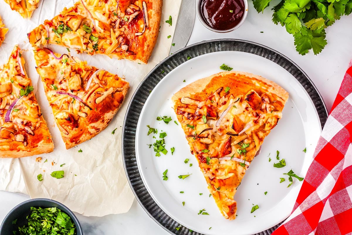 A slice of pizza on a white plate.