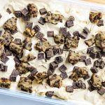 Cookie dough pieces and chocolate chunks on top of ice cream.