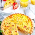 The finshed quiche with a slice taken from it so you can see the creamy interior.