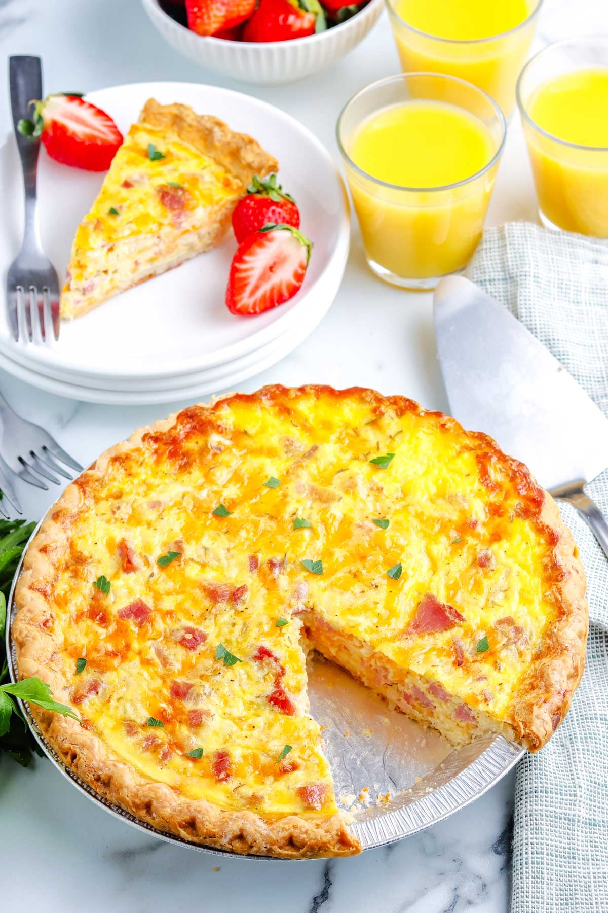The finshed quiche with a slice taken from it so you can see the creamy interior.