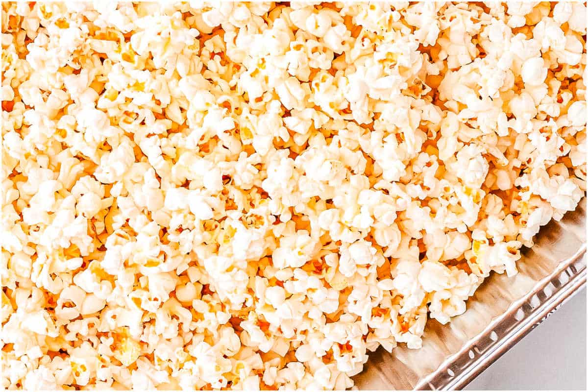 Popped popcorn in a foil pan.