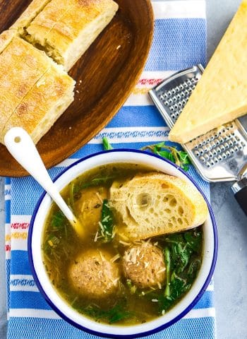 Overhead picture of Italian wedding soup served with bread.