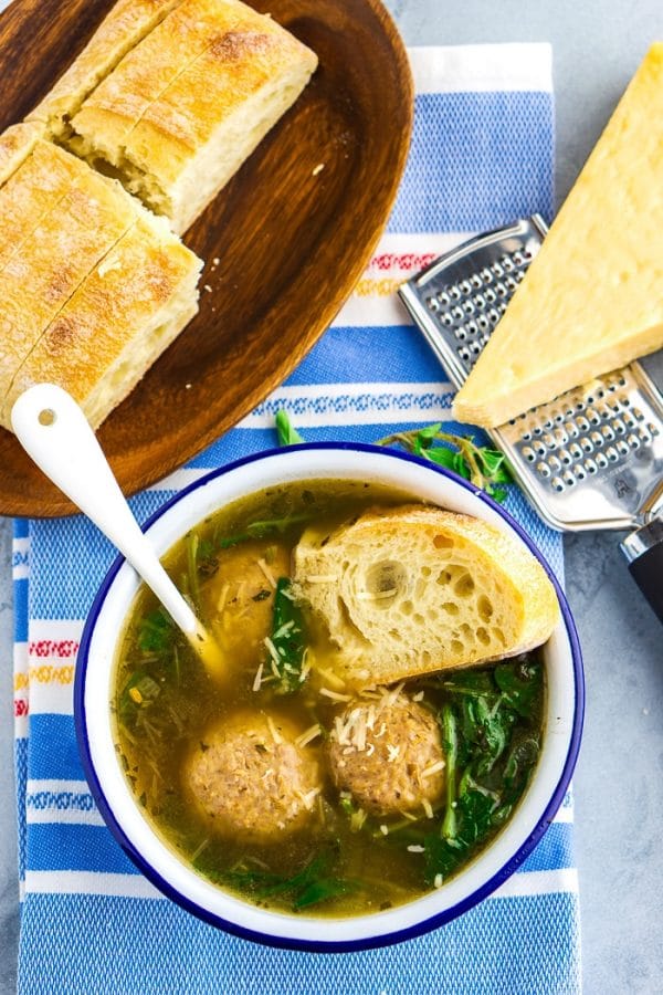Overhead picture of Italian wedding soup served with bread. 