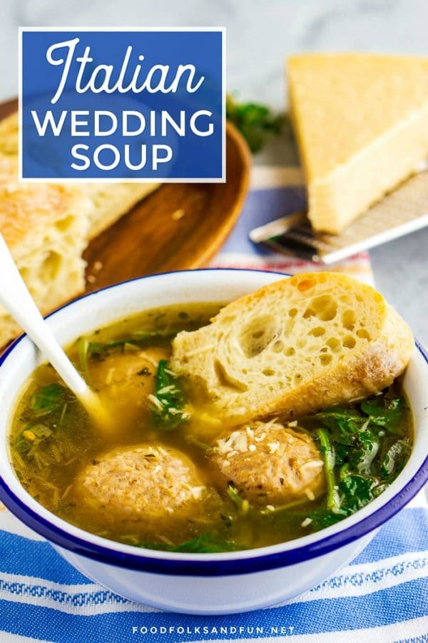 Wedding Soup in a white bowl with bread and Parmesan with text overlay for Pinterest. 
