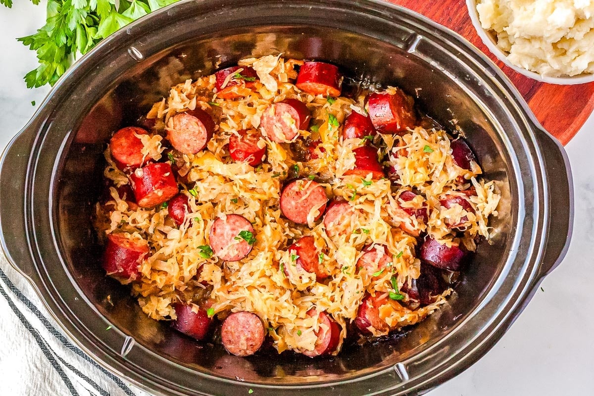 The finished Slow Cooker Kielbasa and Sauerkraut in a crockpot insert.