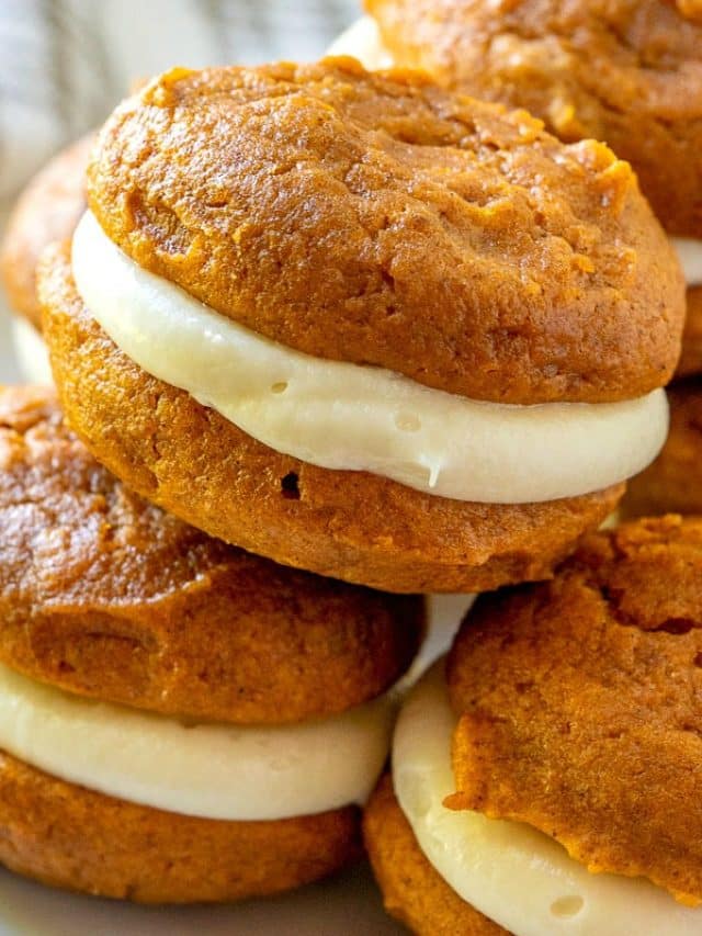 A close up picture of a stack of pumpkin whoopie pies.