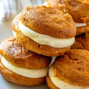 A close up picture of a stack of pumpkin whoopie pies.
