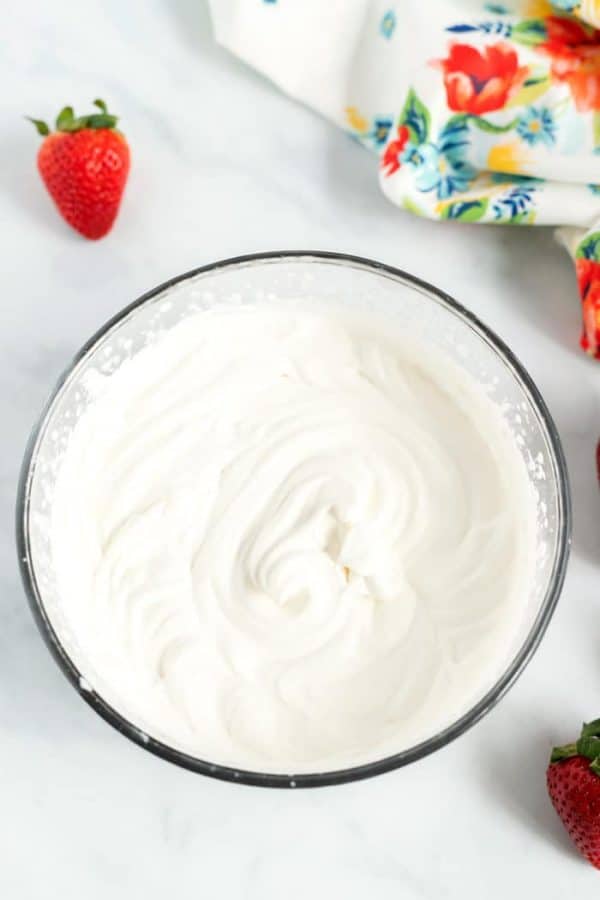 Overhead picture of whipped cream in a mixing bowl. 