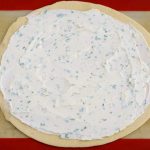 Spread the herbed goat cheese out evenly over the pie crust.