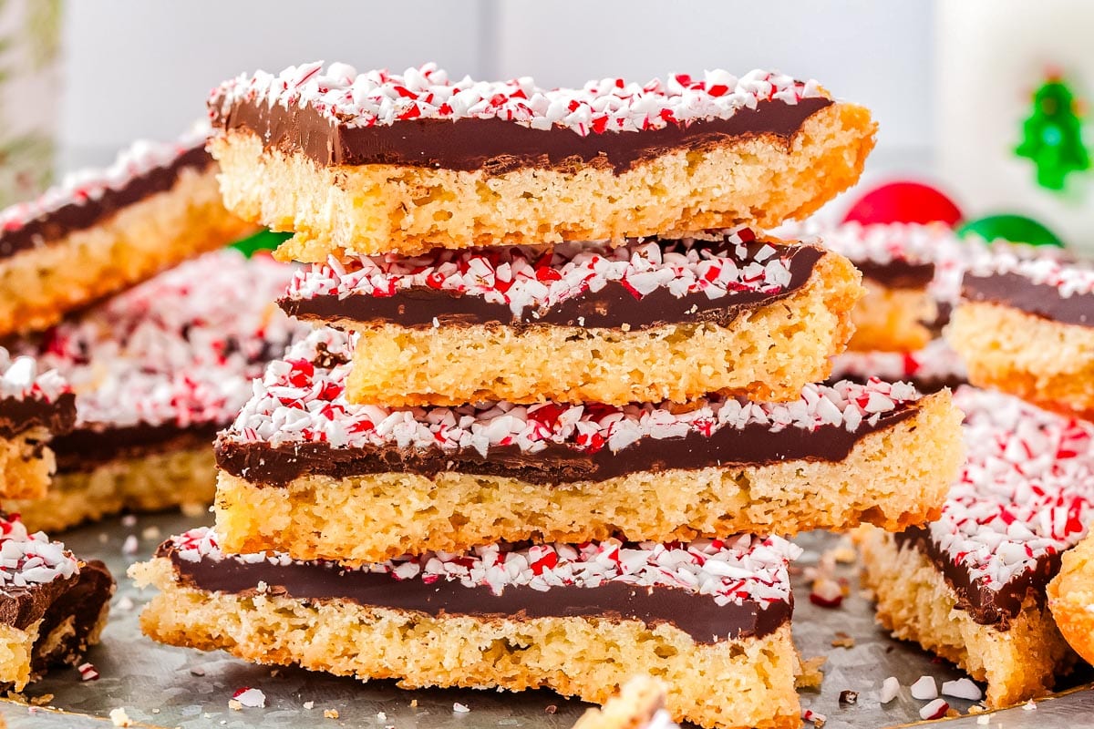 A stack of 4 peppermint bark cookies on a platter.