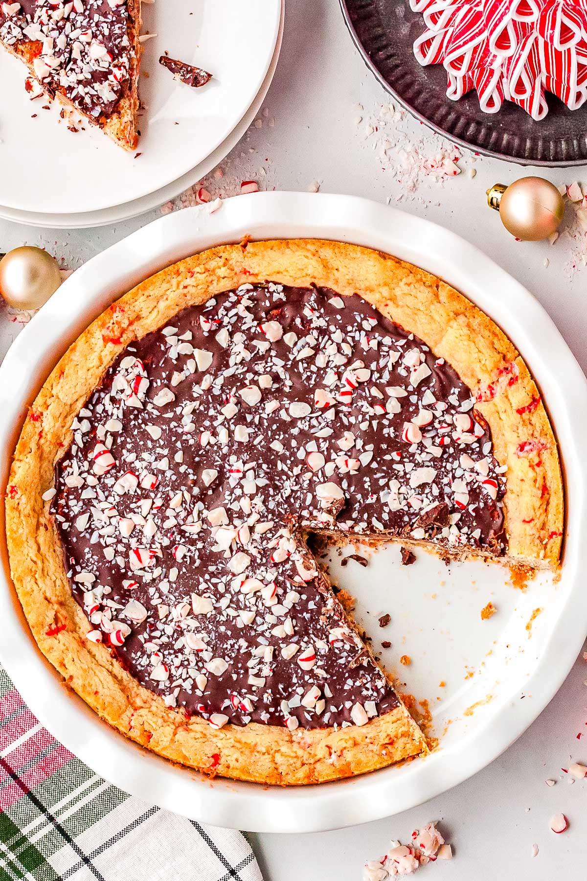 The Peppermint Bark sugar cookie pie in a white pie plate.